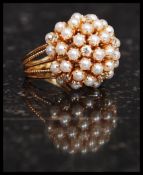 A stunning 18 / 22ct gold, diamond and seed pearl cluster ring.
