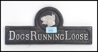 A vintage style cast iron ' Dogs Running Loose ' gate sign.