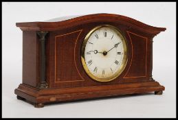 An Edwardian mahogany inlaid mantel clock.