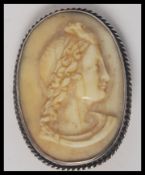 A Victorian Ivory / Bone cameo carved with the Head of a Bacchante mounted on a silver metal brooch