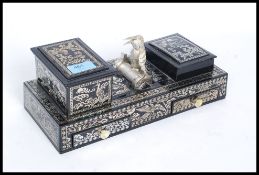 A retro mid century kitsch cigarette dispenser in black lacquer with mother of pearl style finish