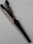 A pair of silver embellished glove stretchers.