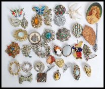 A large collection of costume jewellery brooches to include mid century.