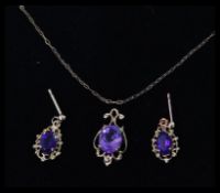 A 9ct gold and amethyst pendant & necklace together with near matching earrings.