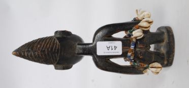 A Yoruba / Yorouba African tribal figure of softwood construction adorned with beads and shells