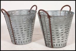 A pair of Industrial metal and cast iron oyster catchers.