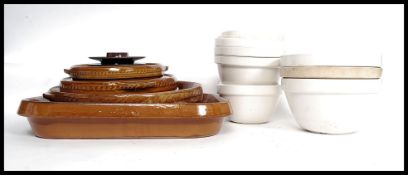 A collection of retro stoneware cooking pots along with a collection of ceramic cooking / pudding