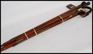 A collection of walking sticks together with a lot of mahogany set squares and a large spirit level.