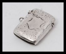 An Edwardian silver hallmarked vesta being chase decorated with plain cartouche.