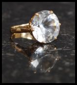 A stunning 18ct yellow gold dress ring with inset large round cut white sapphire being claw mounted