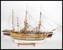 Two vintage 20th century model ships being scratchbuilt,