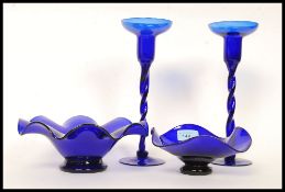 A pair of Bristol blue glass barleytwist stem candlesticks with deep sconces to each together with