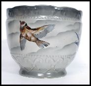 A decorative mid century Empire ware large Staffordshire ceramic planter being decorated with