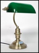 A 20th century contemporary antique style brass effect bankers desk top lamp with angular green