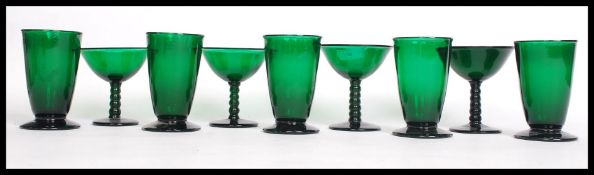 A collection of handmade green glass rummers and cocktail martini glasses - possibly Bristol