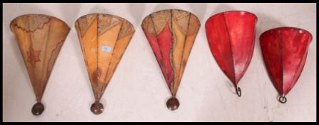 A collection of 20th century tribal influence Morrocan goat skin and wrought iron wall hanging