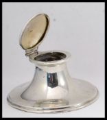 A solid silver hallmarked desk top inkwell complete with the original clear glass liner within