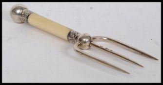 A hallmarked silver and ivory handled fork.