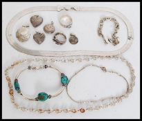 A group of silver jewellery items to include necklaces, bracelets, ring, lockets and pendants.