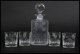 A good quality cut glass and etched decorated decanter together with 4 matching whisky tumblers