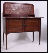 An Edwardian mahogany inlaid marble top washstand.