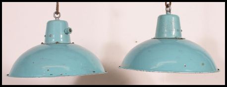 A pair of rare light blue and white mid century factory Industrial pendant lights having rope ties