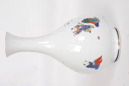 A 20th century Fukagawa vase of baluster form with white ground decorated with children at play.