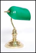 A 20th century antique style brass effect bankers lamp with green and white glass shade