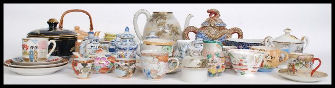 A collection of Chinese / oriental ceramics to include translucent cups and saucers, teapots,