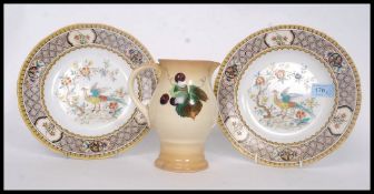 A pair of Mintons for Lawley hand painted cabinet plates depicting foliates and birds of paradise