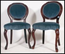 A pair of French balloon back upholstered bedroom chairs.