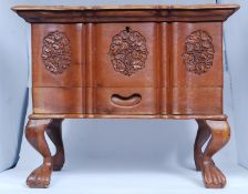 A 20th century large carved wooden Chinese jewellery box chest raised on shaped suports with single