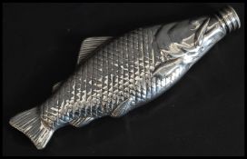 A Silver metal novelty hip flask in the form of a fish having a screw top lid.