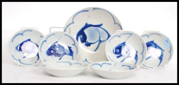 A collection of studio style blue and white ceramic Chinese bowls along with the serving bowl,