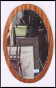 A vintage 1970's oval teak wall mirror.