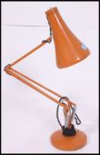 A vintage retro industrial Herbert Terry anglepoise lamp light in orange / amber colour. 85cm tall.
