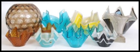 A collection of assorted glass / ceramic handkerchief vases.