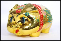 A 20th century Chinese ceramic statue money box in the form of a pig,