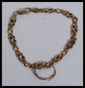 A 9ct gold / 375 marked unusual kerb lined bracelet with circular pendant. Complete with clas.