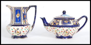 A Royal Winton Ivory Ware teapot complete with a matching jug. Both stamped to the base.