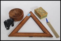 A mixed lot to include a triangular treen cribbage board, other treen items, hardwood elephant,