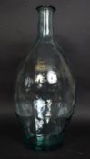 A large bulbous shaped clear glass continental olive jar bottle.