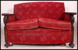 A 1930's Oak cottage suite comprising 2 armchairs and a 2 seat sofa settee.