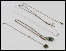 A collection of silver necklaces to include crucifix pendant, CZ stone,