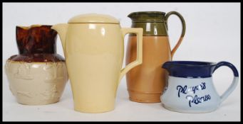 A collection of jugs to include a Players Please water jug, Wedgwood Bourn VIta jug,