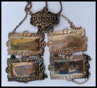 A collection of 5 silver plated decanter labels.