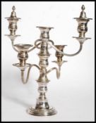 A silver plated five branch candelabra cast with acanthus leaves and rococo scrolls.