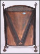 A vintage early 20th century brass / copper fire guard along with a pair of brass fire dogs.