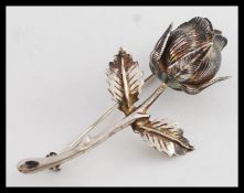 A hallmarked silver rose brooch, with leaves to sides and hallmarks to rear.