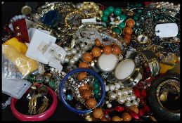 A collection of costume jewellery to include malachite mid century bead necklace, silver earrings,